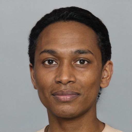 Joyful black young-adult male with short  black hair and brown eyes