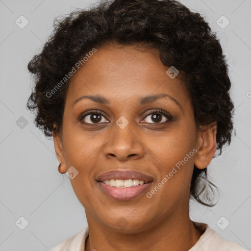 Joyful black adult female with short  brown hair and brown eyes