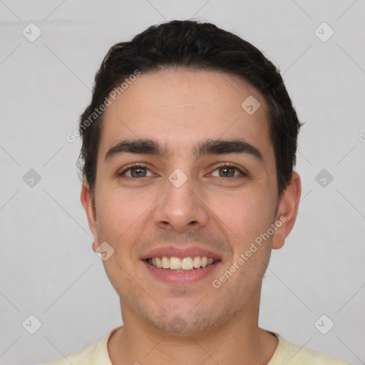 Joyful white young-adult male with short  black hair and brown eyes