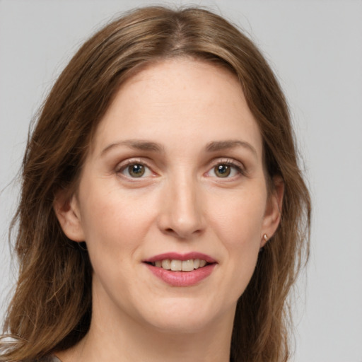 Joyful white young-adult female with long  brown hair and green eyes