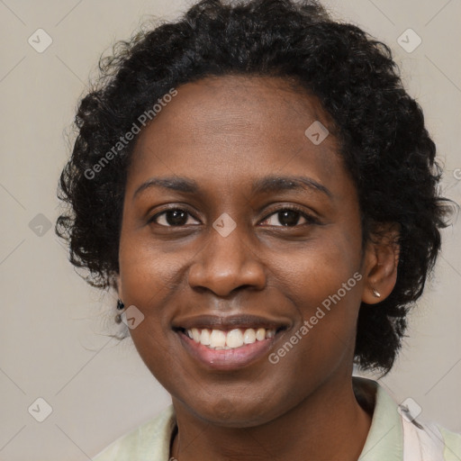 Joyful black young-adult female with long  black hair and brown eyes