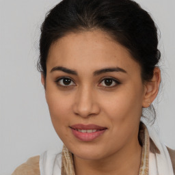 Joyful latino young-adult female with medium  brown hair and brown eyes