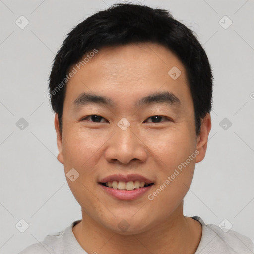 Joyful asian young-adult male with short  black hair and brown eyes