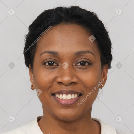 Joyful black young-adult female with short  black hair and brown eyes