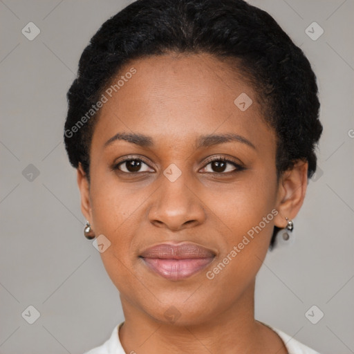 Joyful black young-adult female with short  black hair and brown eyes