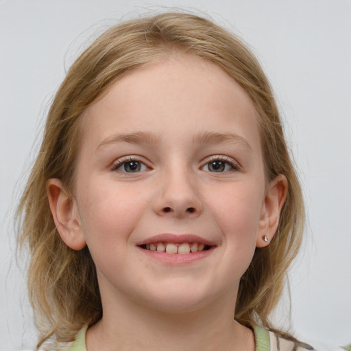 Joyful white child female with medium  brown hair and blue eyes