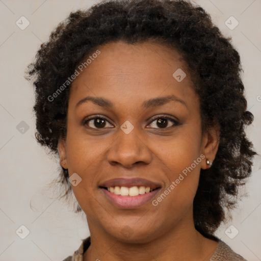 Joyful black adult female with short  brown hair and brown eyes