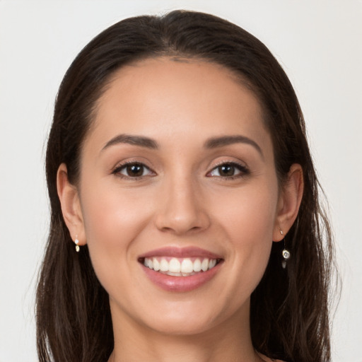 Joyful white young-adult female with long  brown hair and brown eyes