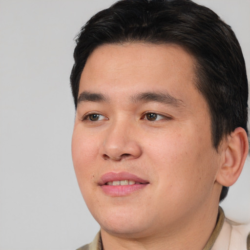 Joyful asian young-adult male with short  brown hair and brown eyes