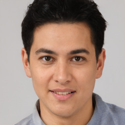 Joyful asian young-adult male with short  brown hair and brown eyes