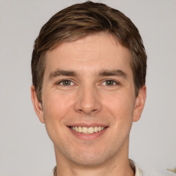 Joyful white young-adult male with short  brown hair and brown eyes