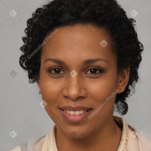 Joyful black adult female with short  brown hair and brown eyes