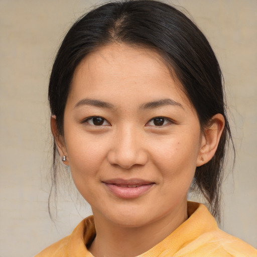 Joyful asian young-adult female with medium  brown hair and brown eyes