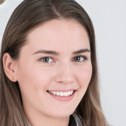 Joyful white young-adult female with long  brown hair and blue eyes