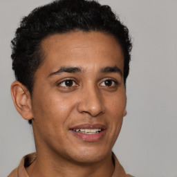 Joyful latino young-adult male with short  brown hair and brown eyes