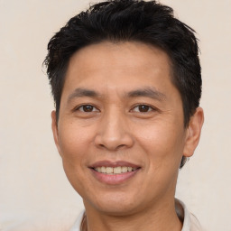 Joyful asian adult male with short  brown hair and brown eyes