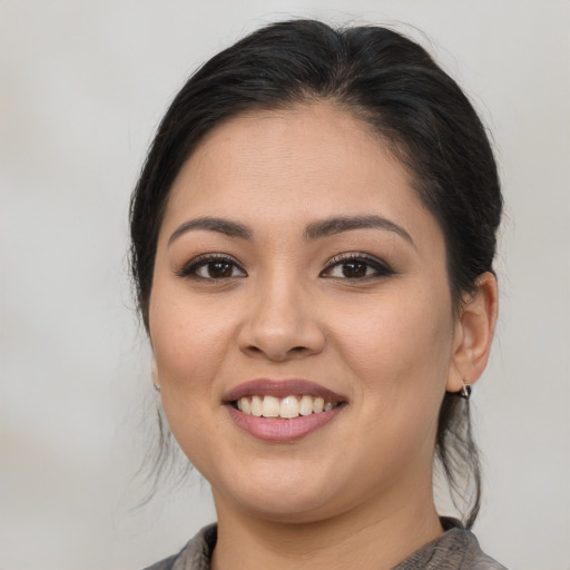 Joyful asian young-adult female with medium  brown hair and brown eyes