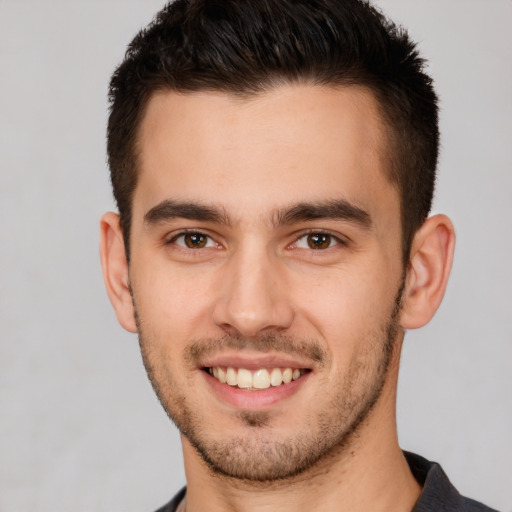 Joyful white young-adult male with short  brown hair and brown eyes