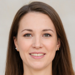 Joyful white young-adult female with long  brown hair and brown eyes