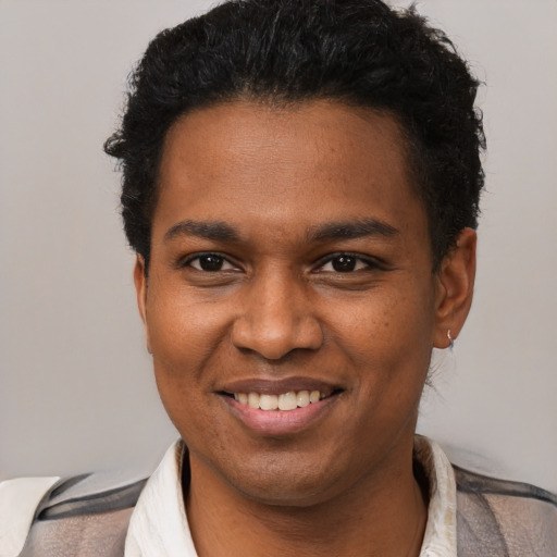 Joyful black young-adult male with short  brown hair and brown eyes