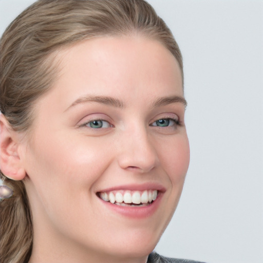 Joyful white young-adult female with long  brown hair and blue eyes