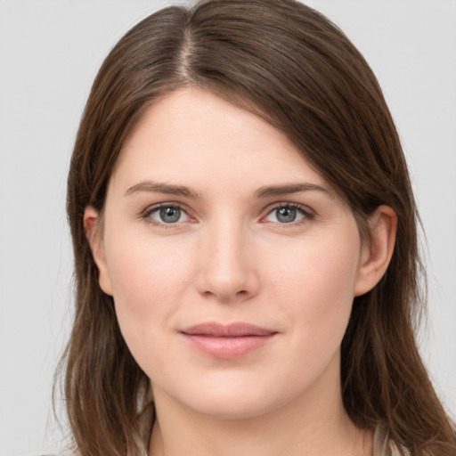 Joyful white young-adult female with long  brown hair and grey eyes