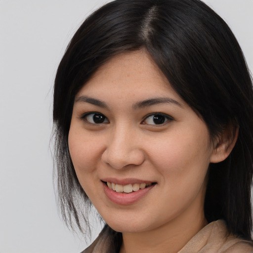 Joyful asian young-adult female with long  brown hair and brown eyes
