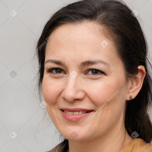 Joyful white adult female with medium  brown hair and brown eyes