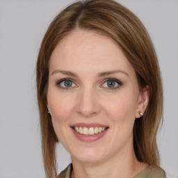 Joyful white young-adult female with medium  brown hair and grey eyes