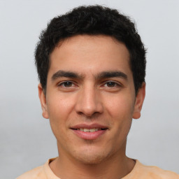 Joyful white young-adult male with short  black hair and brown eyes