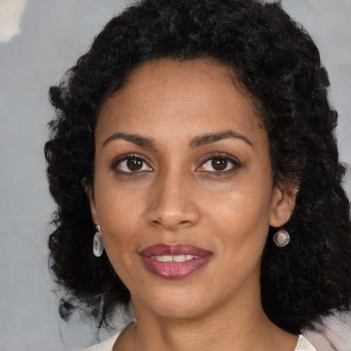 Joyful black young-adult female with medium  black hair and brown eyes