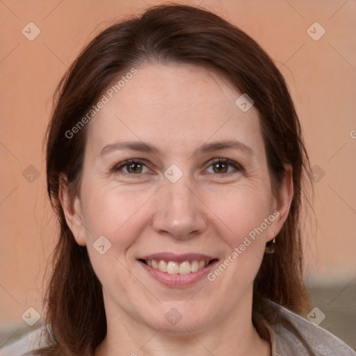 Joyful white adult female with medium  brown hair and brown eyes