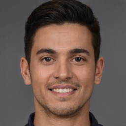 Joyful white young-adult male with short  brown hair and brown eyes