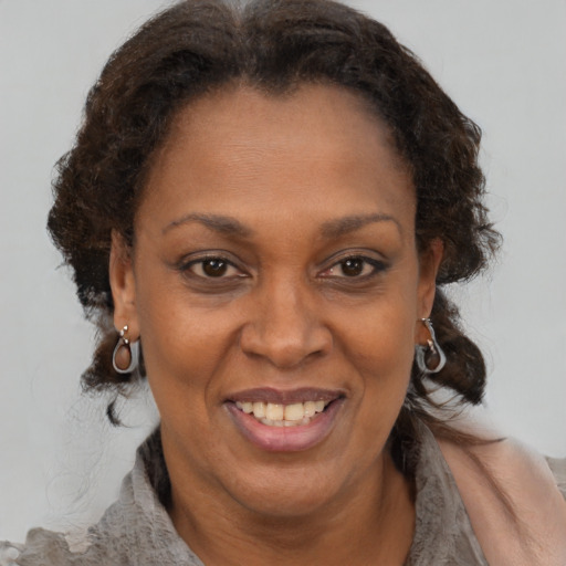 Joyful black adult female with short  brown hair and brown eyes