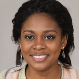 Joyful black young-adult female with long  brown hair and brown eyes