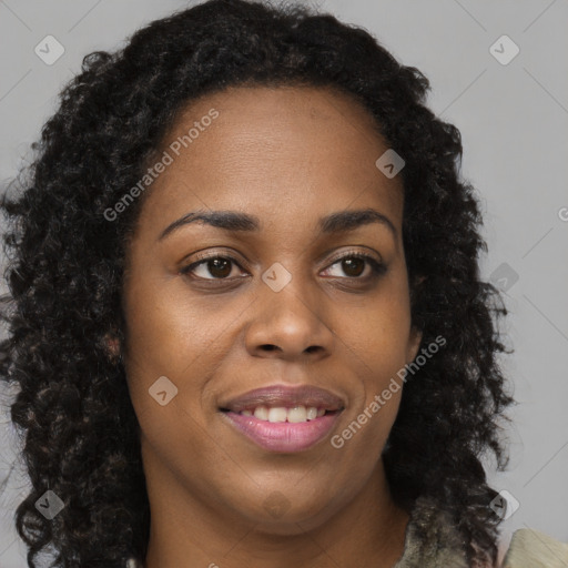 Joyful black young-adult female with long  brown hair and brown eyes