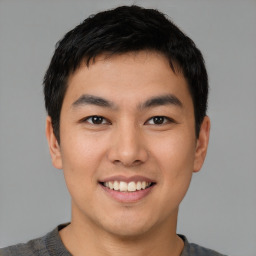 Joyful asian young-adult male with short  black hair and brown eyes