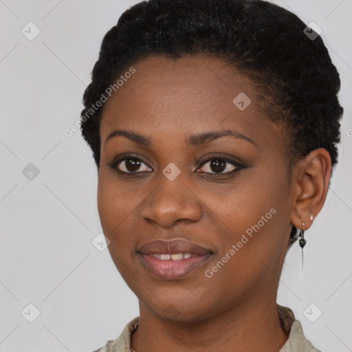 Joyful black young-adult female with short  black hair and brown eyes