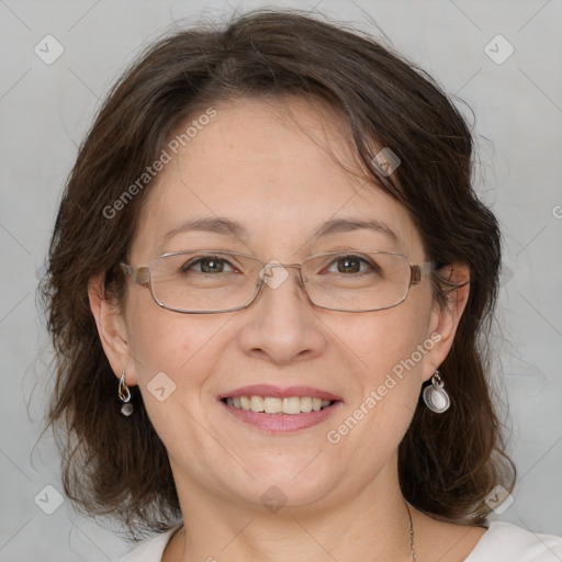 Joyful white adult female with medium  brown hair and blue eyes