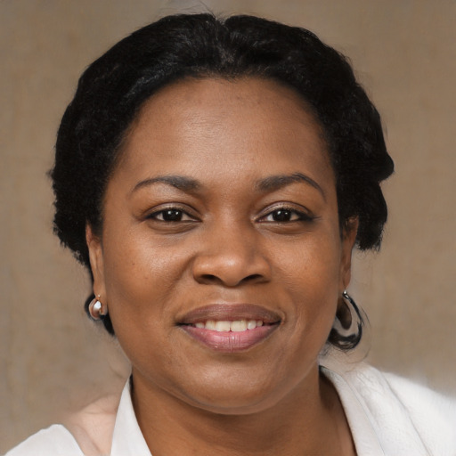 Joyful black adult female with medium  black hair and brown eyes