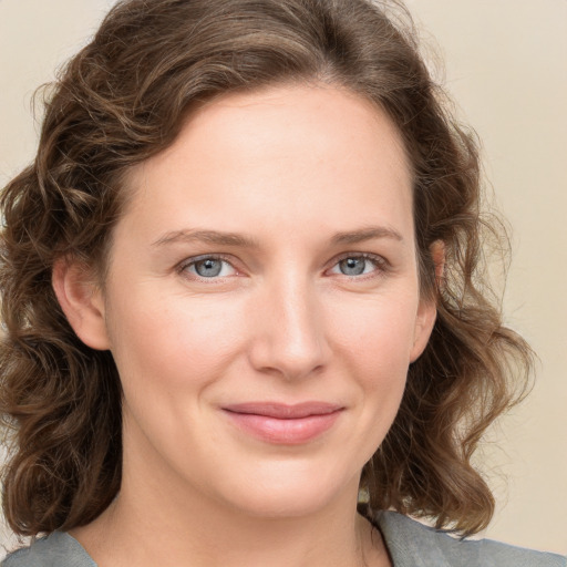 Joyful white young-adult female with medium  brown hair and green eyes