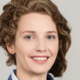 Joyful white young-adult female with medium  brown hair and blue eyes