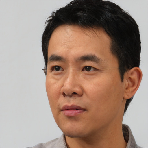 Neutral asian young-adult male with short  black hair and brown eyes