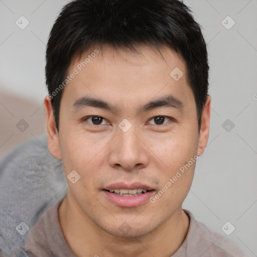 Joyful asian young-adult male with short  brown hair and brown eyes