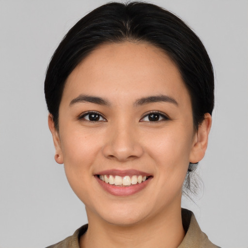 Joyful white young-adult female with medium  black hair and brown eyes