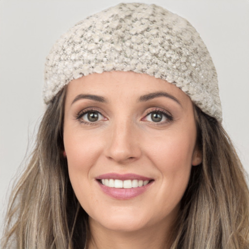 Joyful white young-adult female with long  brown hair and grey eyes