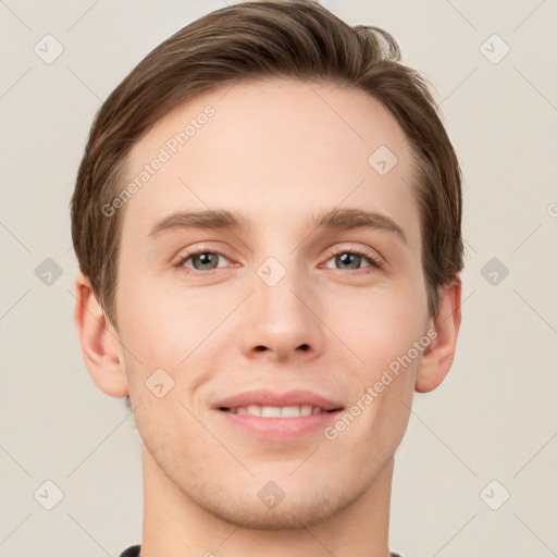 Joyful white young-adult male with short  brown hair and grey eyes