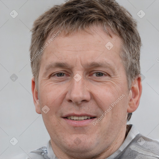 Joyful white adult male with short  brown hair and grey eyes