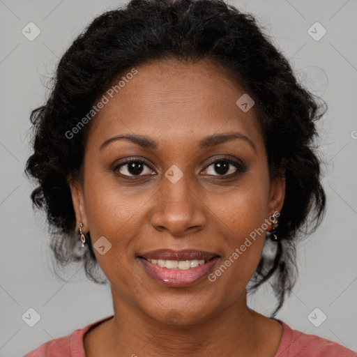 Joyful black adult female with medium  brown hair and brown eyes