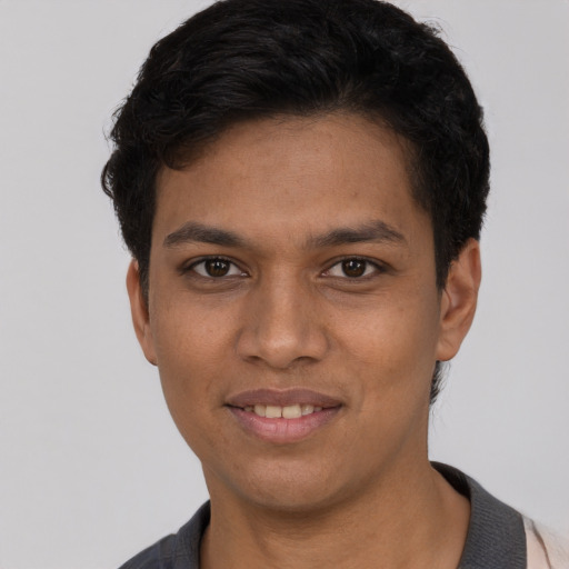 Joyful white young-adult male with short  black hair and brown eyes